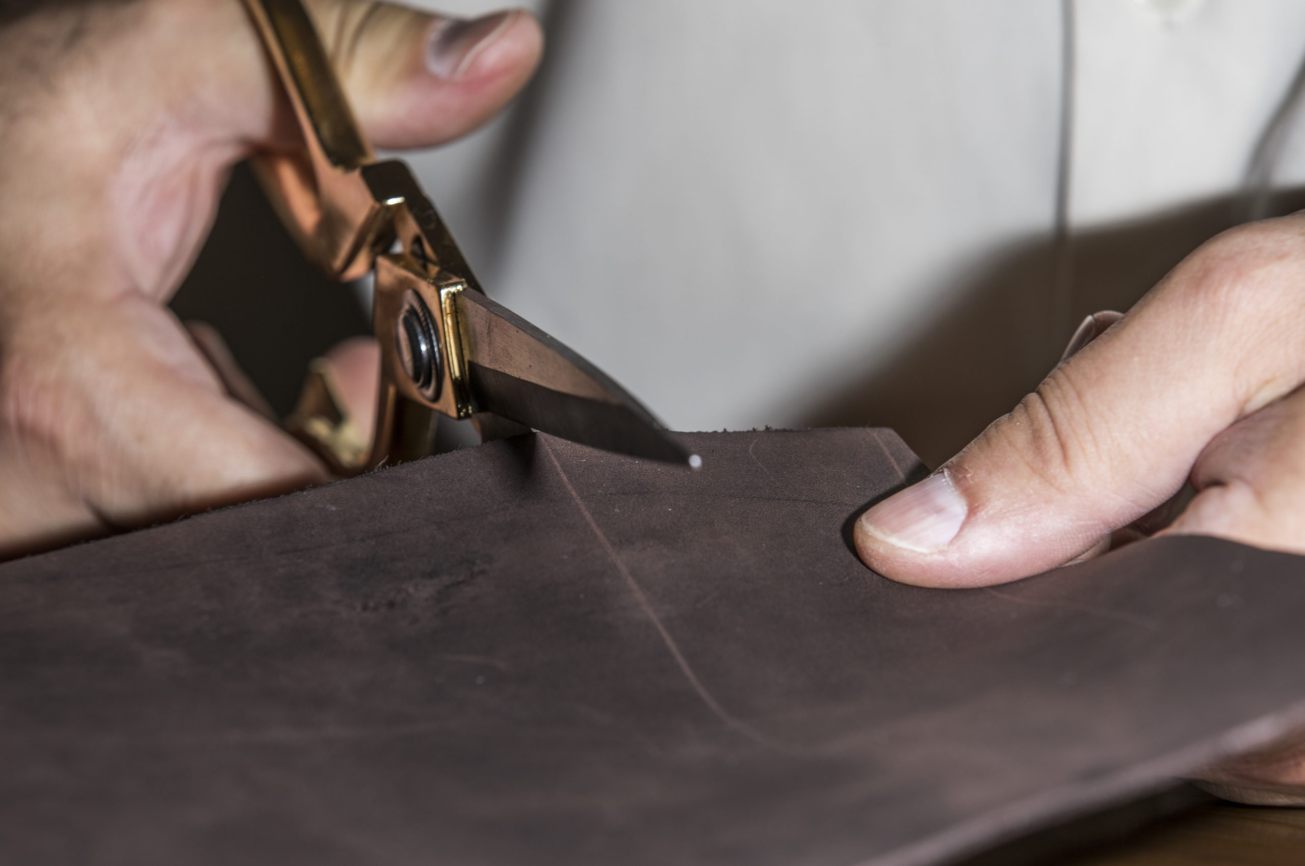 Master cutting leather for tailoring. High quality photo