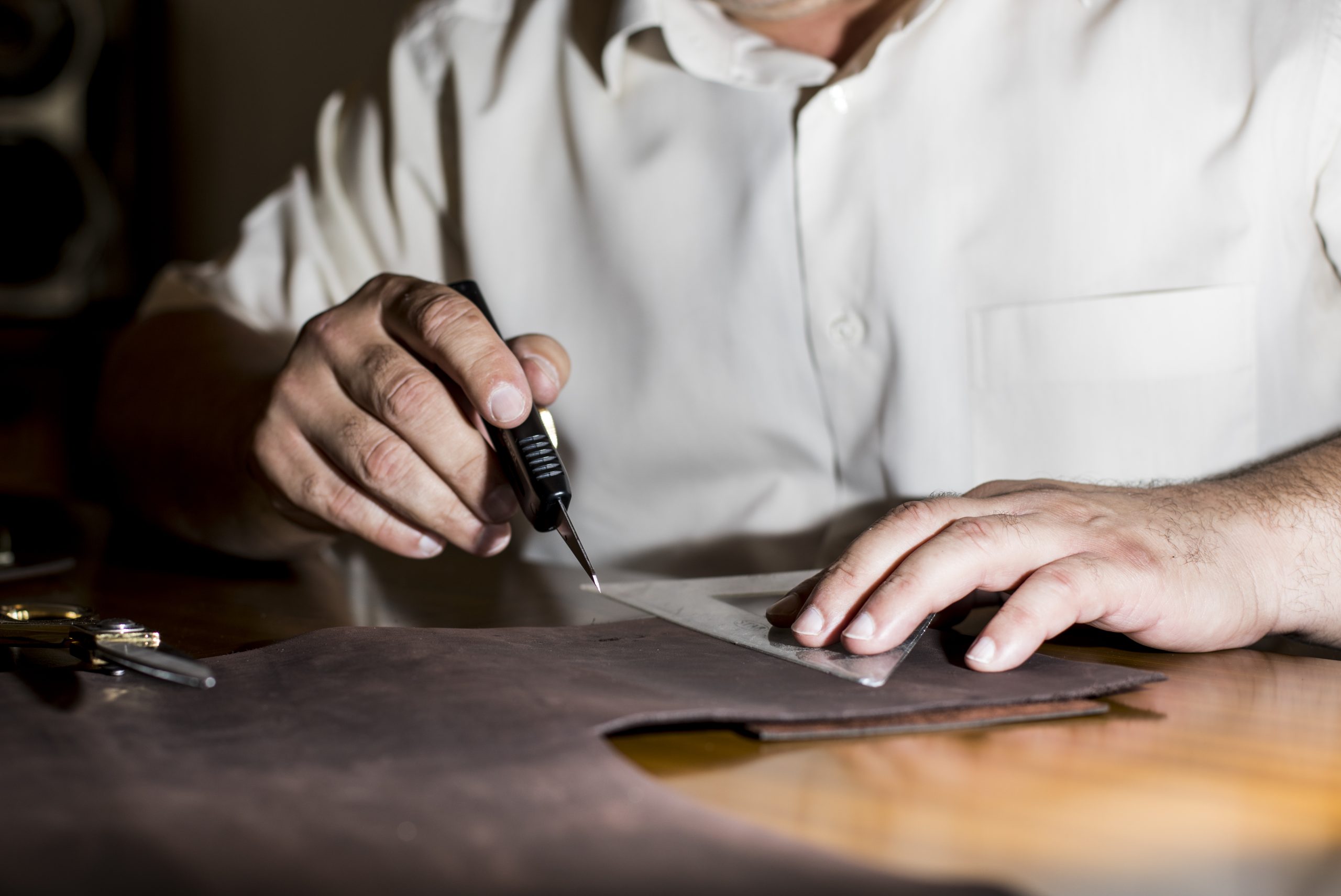Tailor sketching on the leather tissue. High quality photo